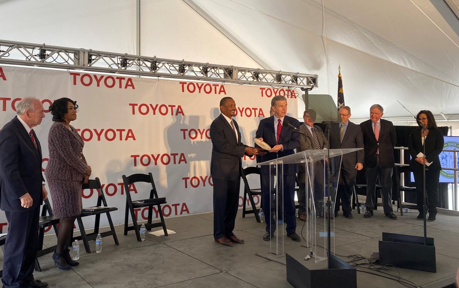 North Carolina's governor, Liberty's mayor, and Toyota officials gather to announce the new battery plant.