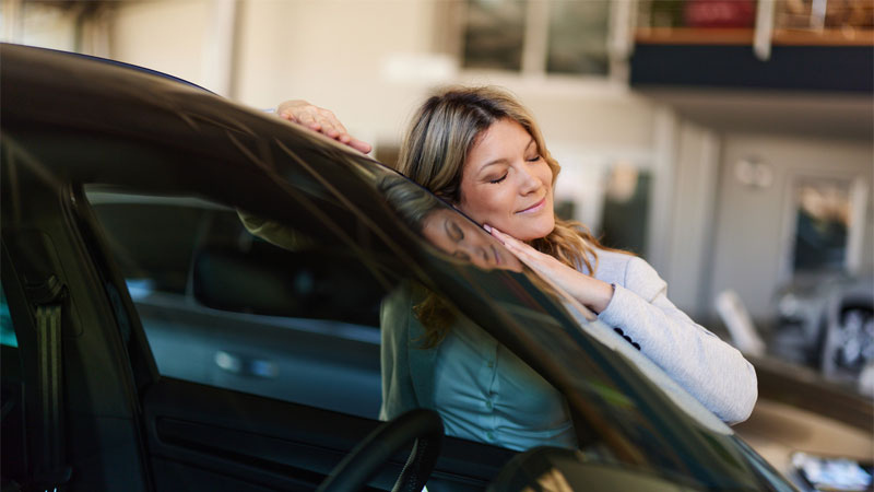 woman hugging car