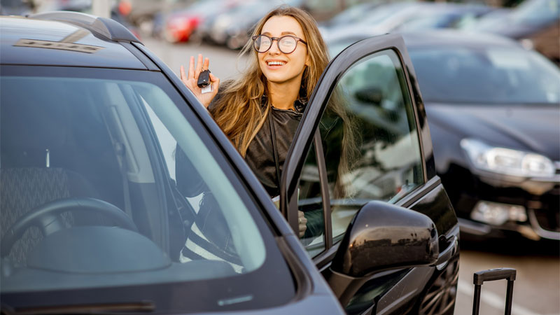 young woman renting car